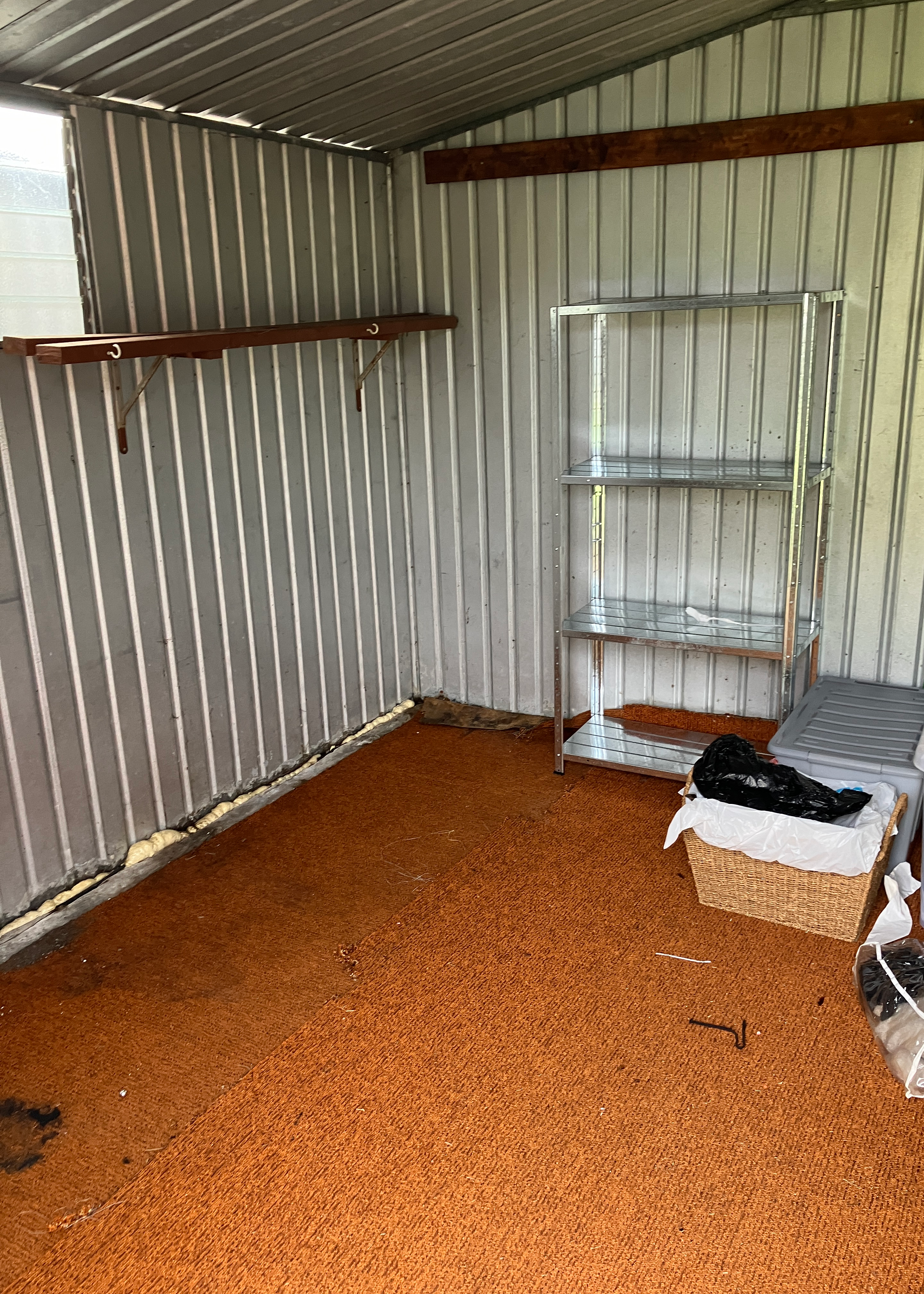 Decluttered storage shed with old flooring