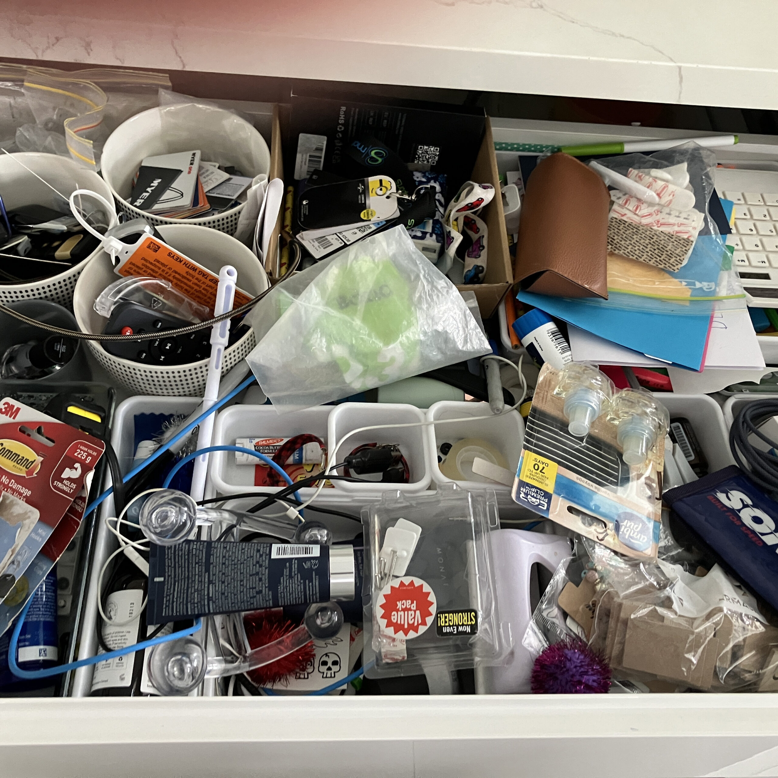 Messy and cluttered kitchen drawer