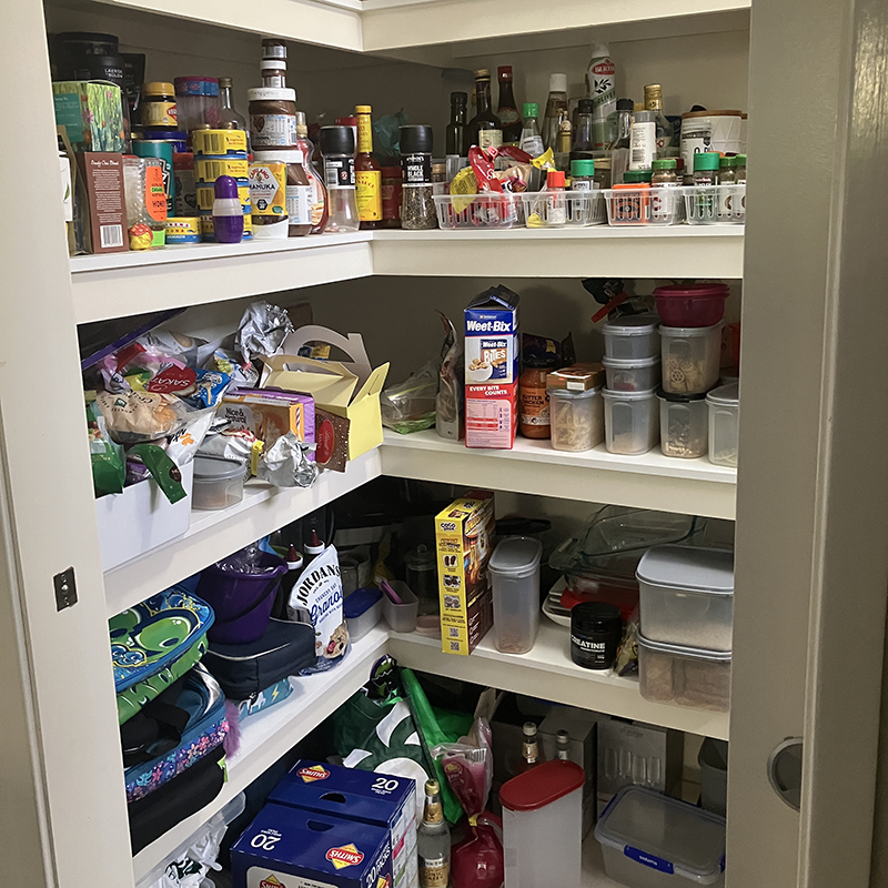 Disorganised and cluttered pantry shelves